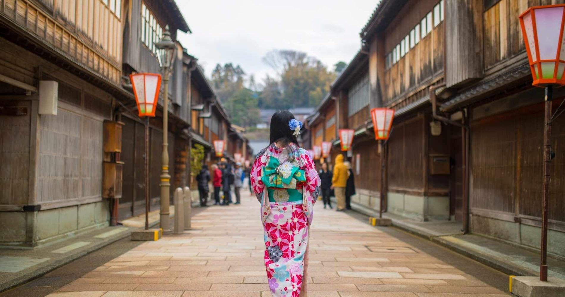 Geisha women walking through traditional wooden building in the Higashi Chaya district