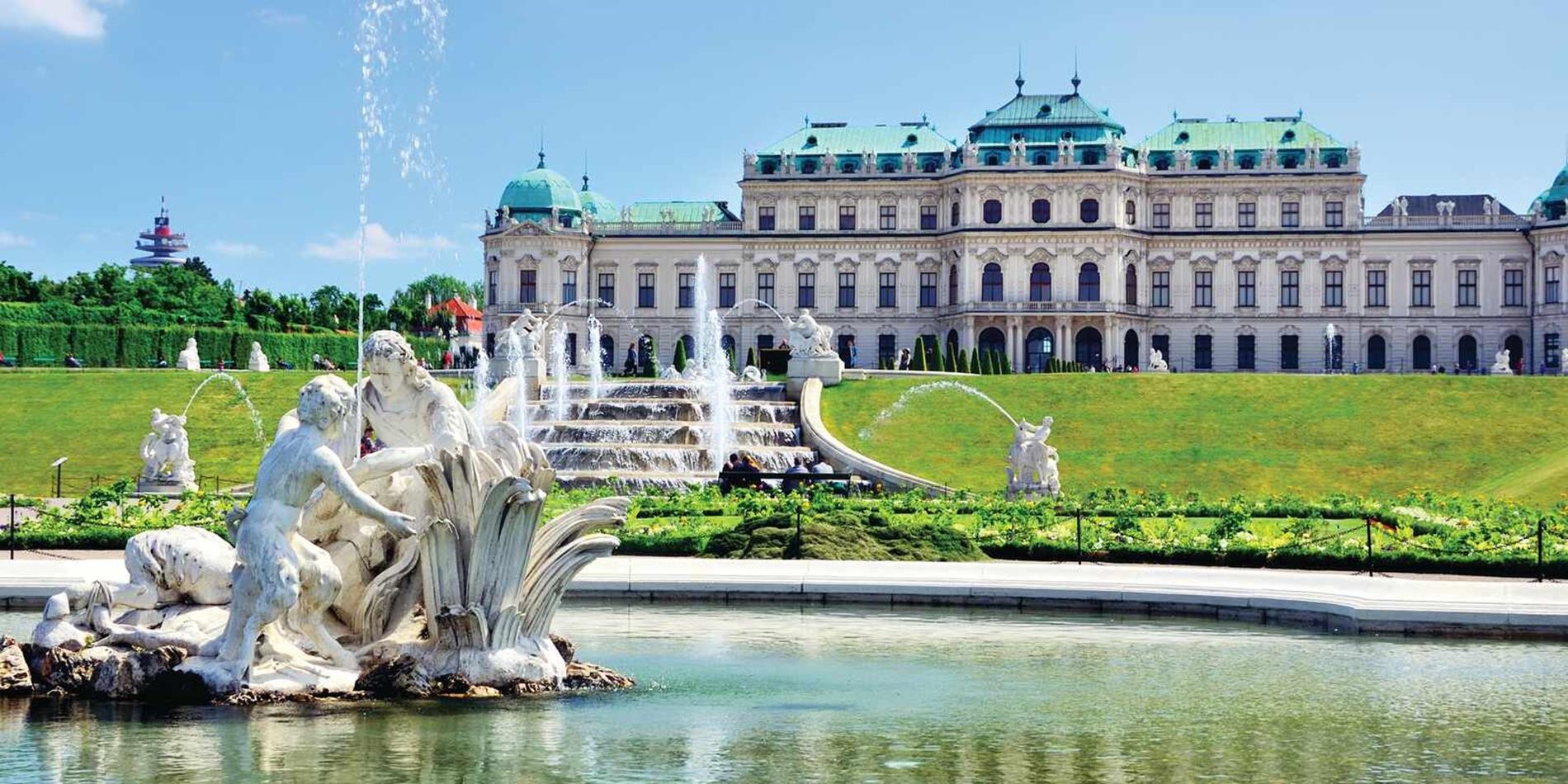 A fountain statue with the Belvedere Palace in the background