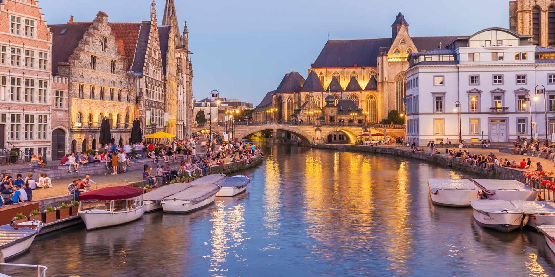Looking down the river to Ghent Old Town at dusk, Belgium