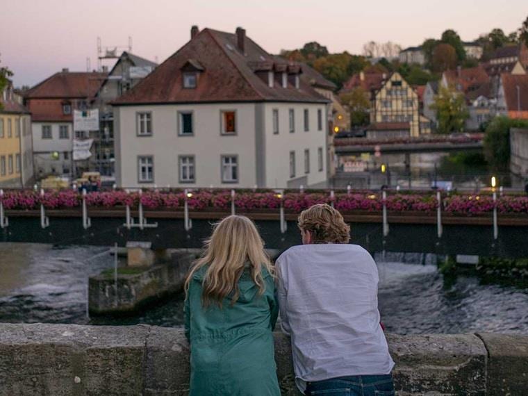 Couple gazing out over the river in Bamburg, Germany